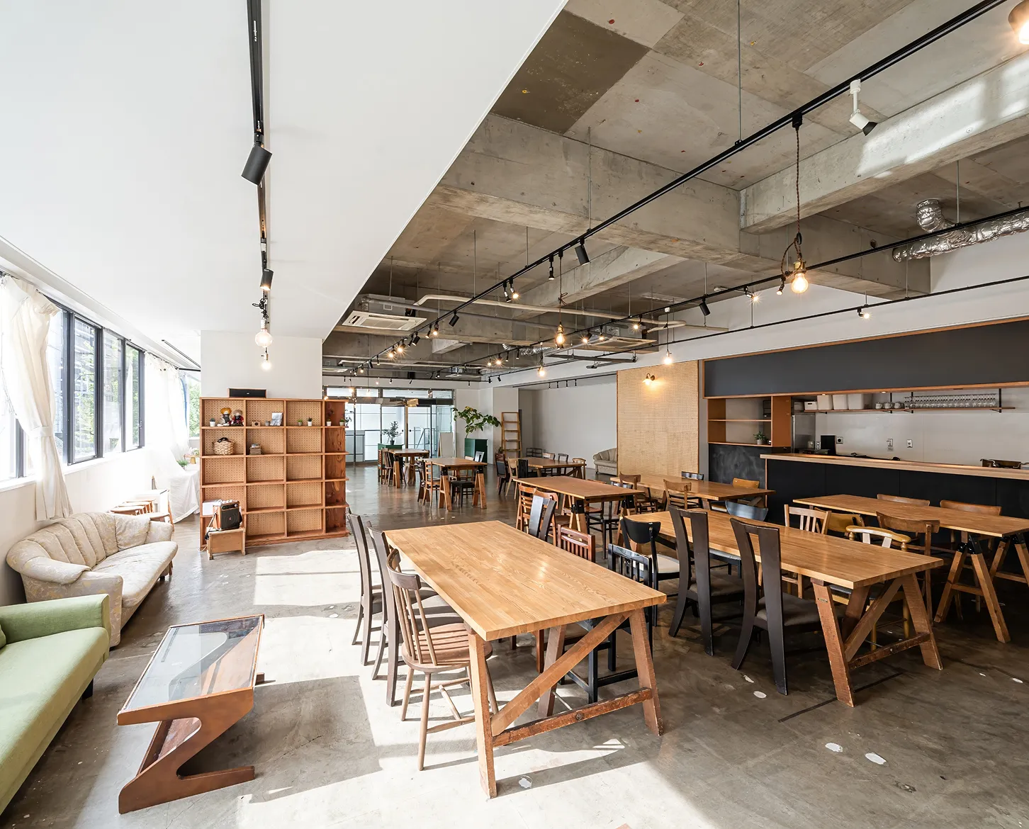 Modern renovated open-concept café with exposed ceilings and natural light.