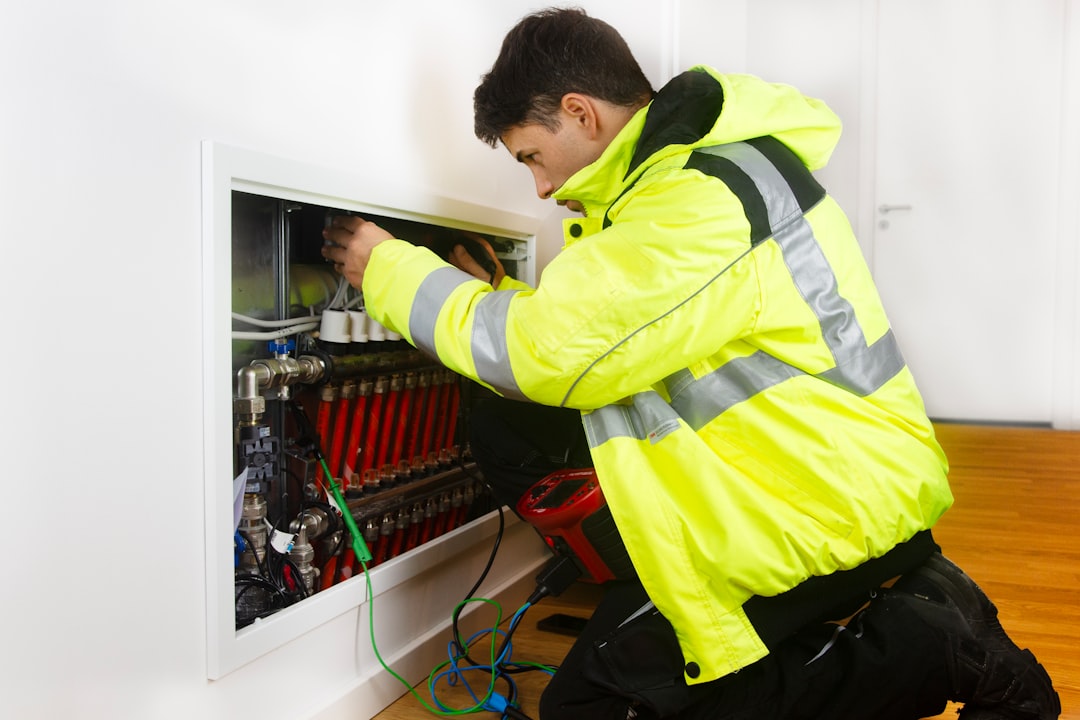 Licensed electrician inspecting a 200-amp electrical panel for EV capacity
