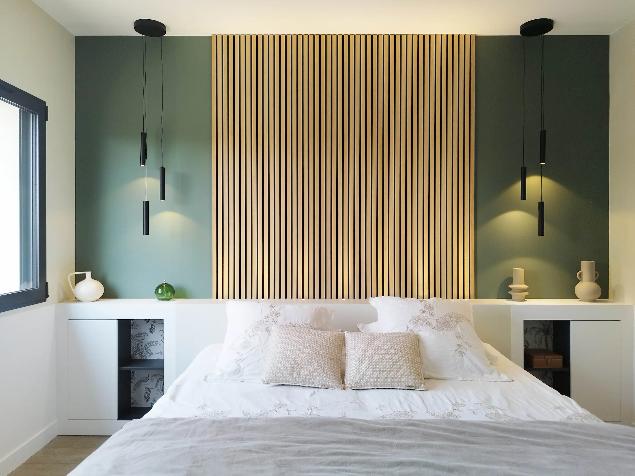 Grande tête de lit en tasseaux bois rétroéclairés, réalisée par Jiwaa.a pour une chambre apaisante.