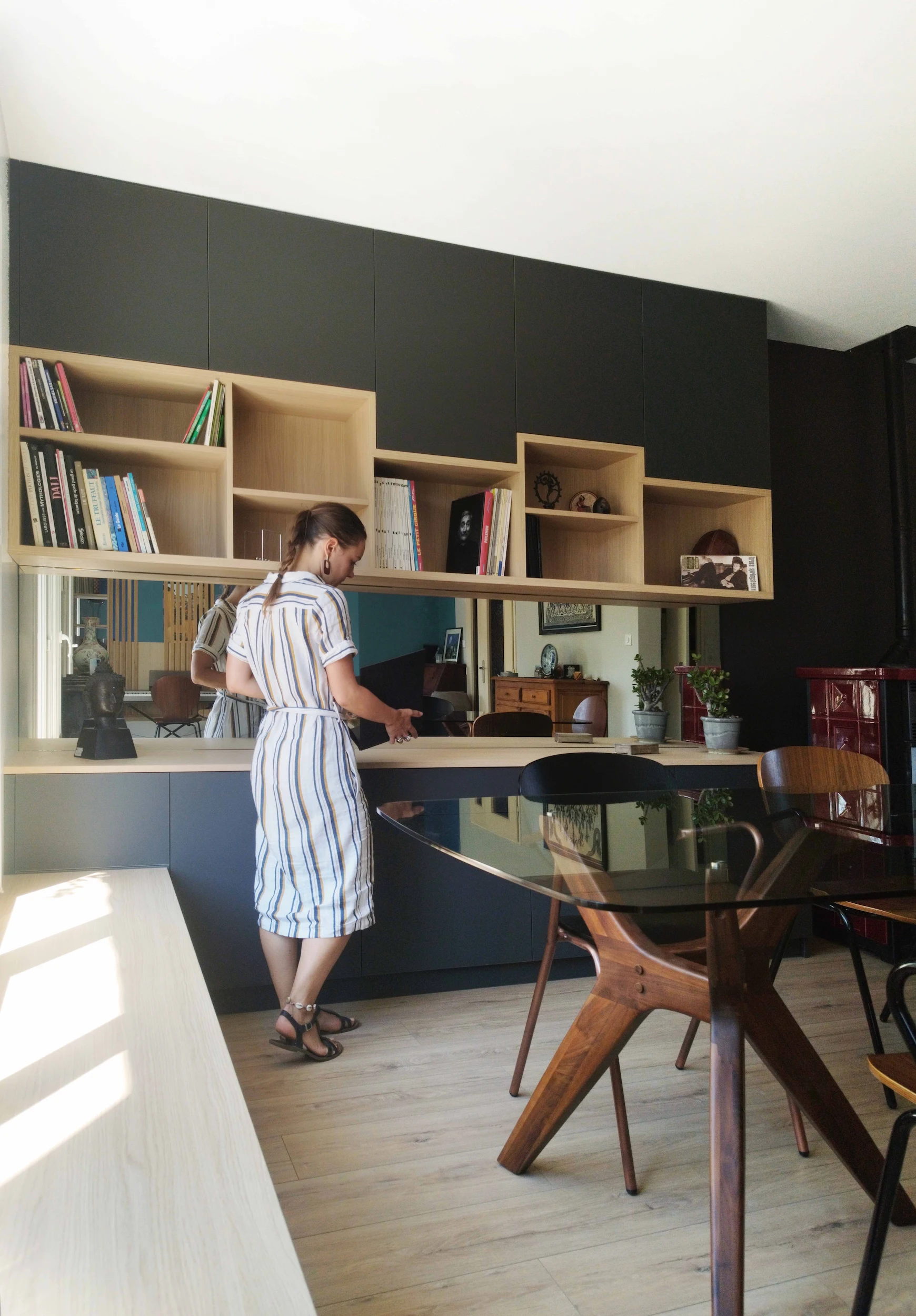 Vue d’ensemble de la bibliothèque sur mesure structurant l’espace salle à manger.