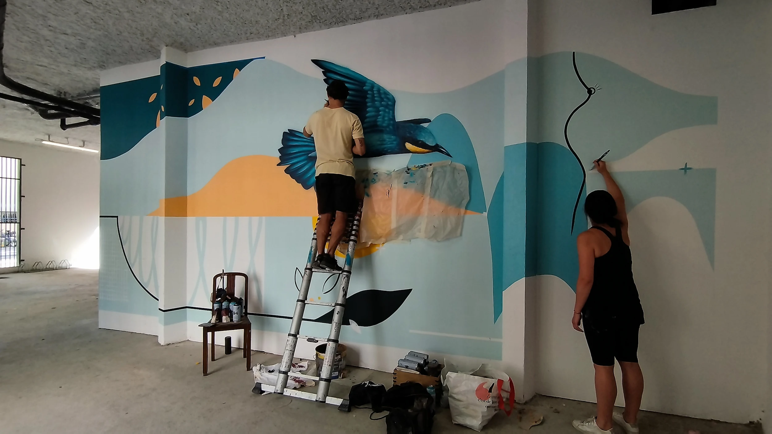 Vue d’ensemble du local vélo en cours de décoration avec fresques murales colorées, projet professionnel mené par Valentine Bourdier, architecte d’intérieur.