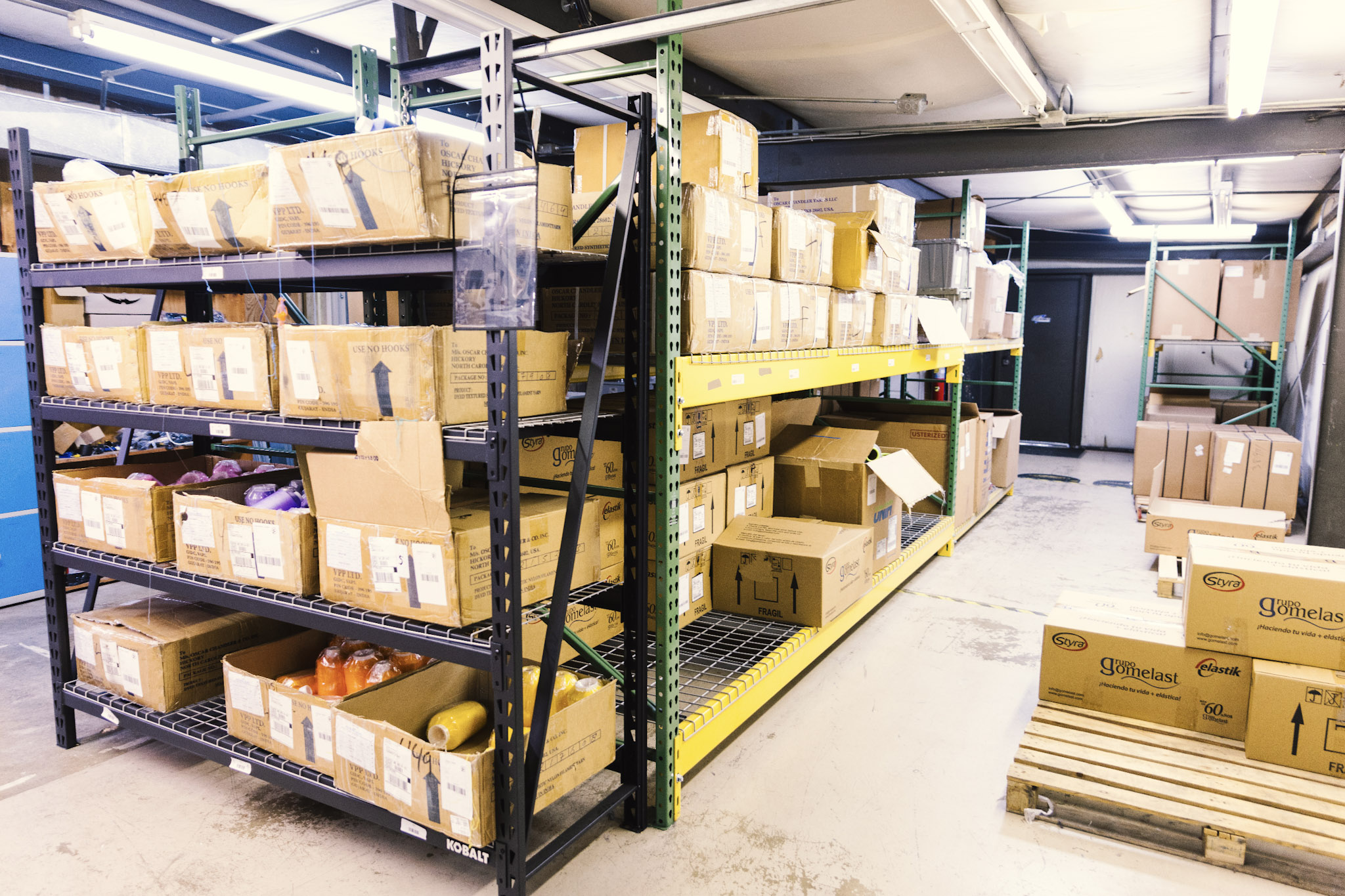 Warehouse workers packing orders for shipment using inventory management workflows.