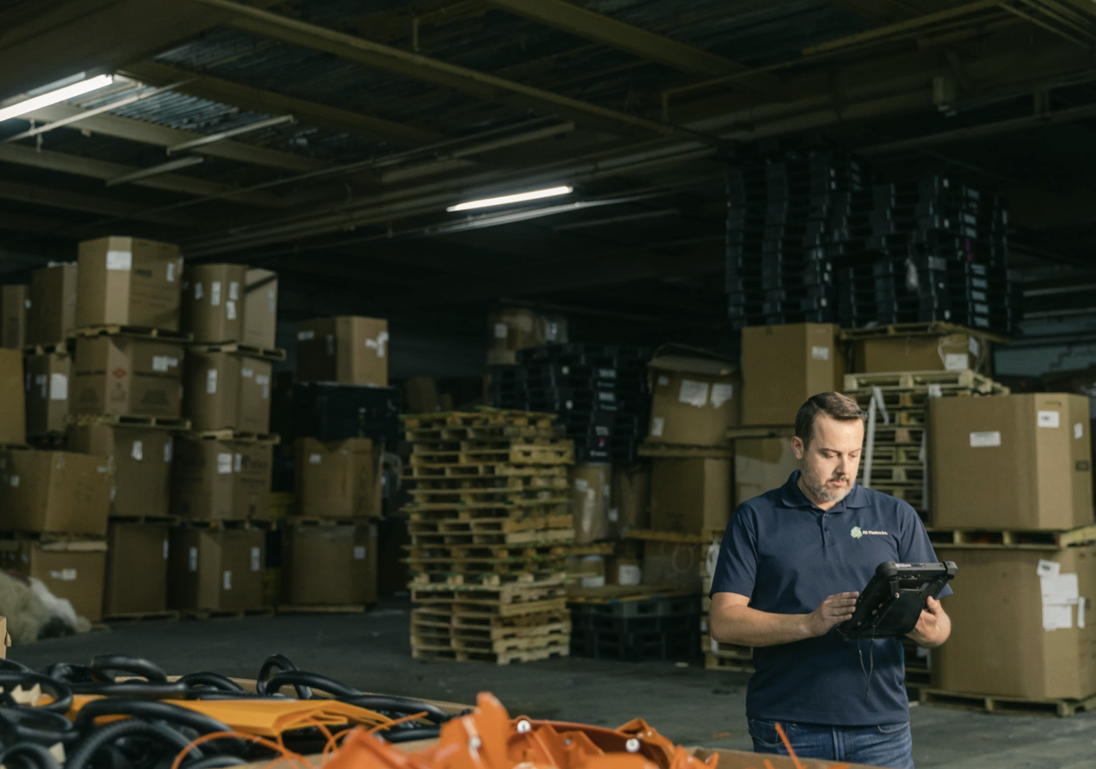 Operator using a tablet to plan production and material requirements.