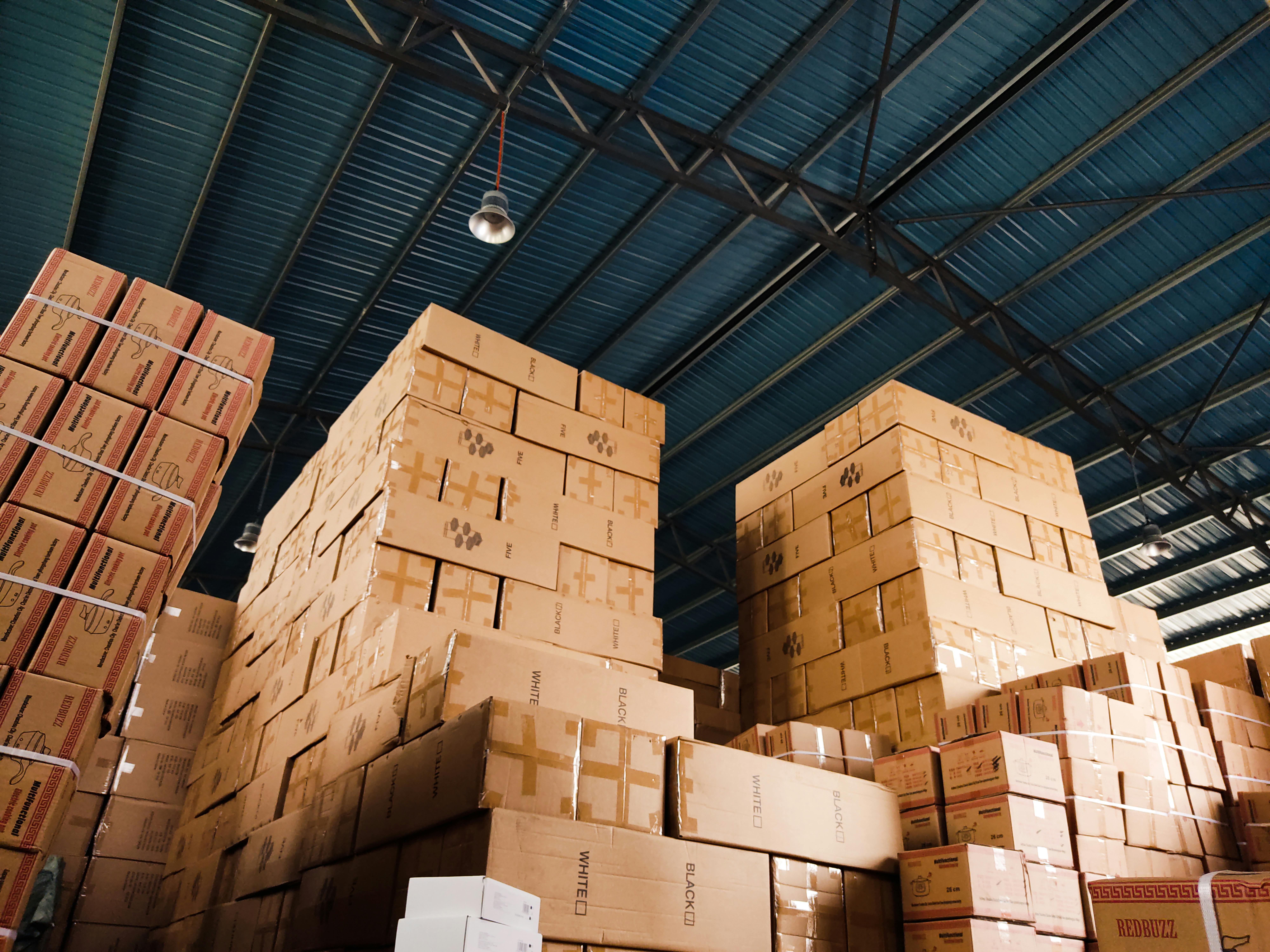 A warehouse with organized shelving stacked with boxed goods. 