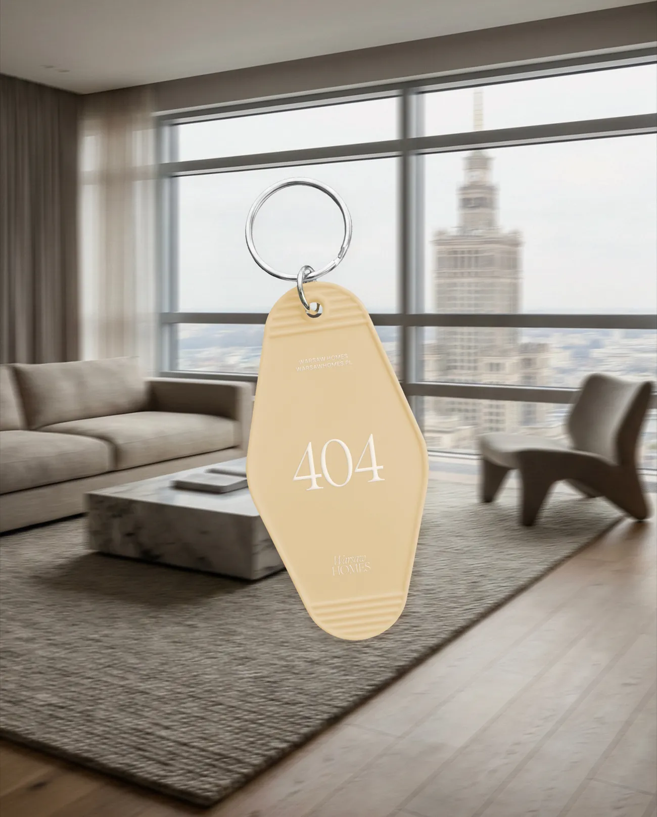 Brelok z logo Warsaw Homes, element identyfikacji marki nieruchomości