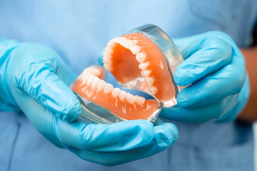 dentist showing dentures and dental implants davie fl