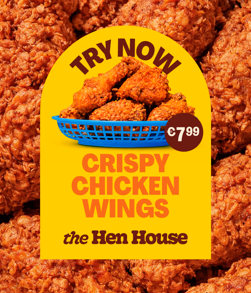 Blue basket filled with crispy fried chicken wings on a yellow background with the text 'TRY NOW CRISPY CHICKEN WINGS the Hen House' and a price tag of €7.99.