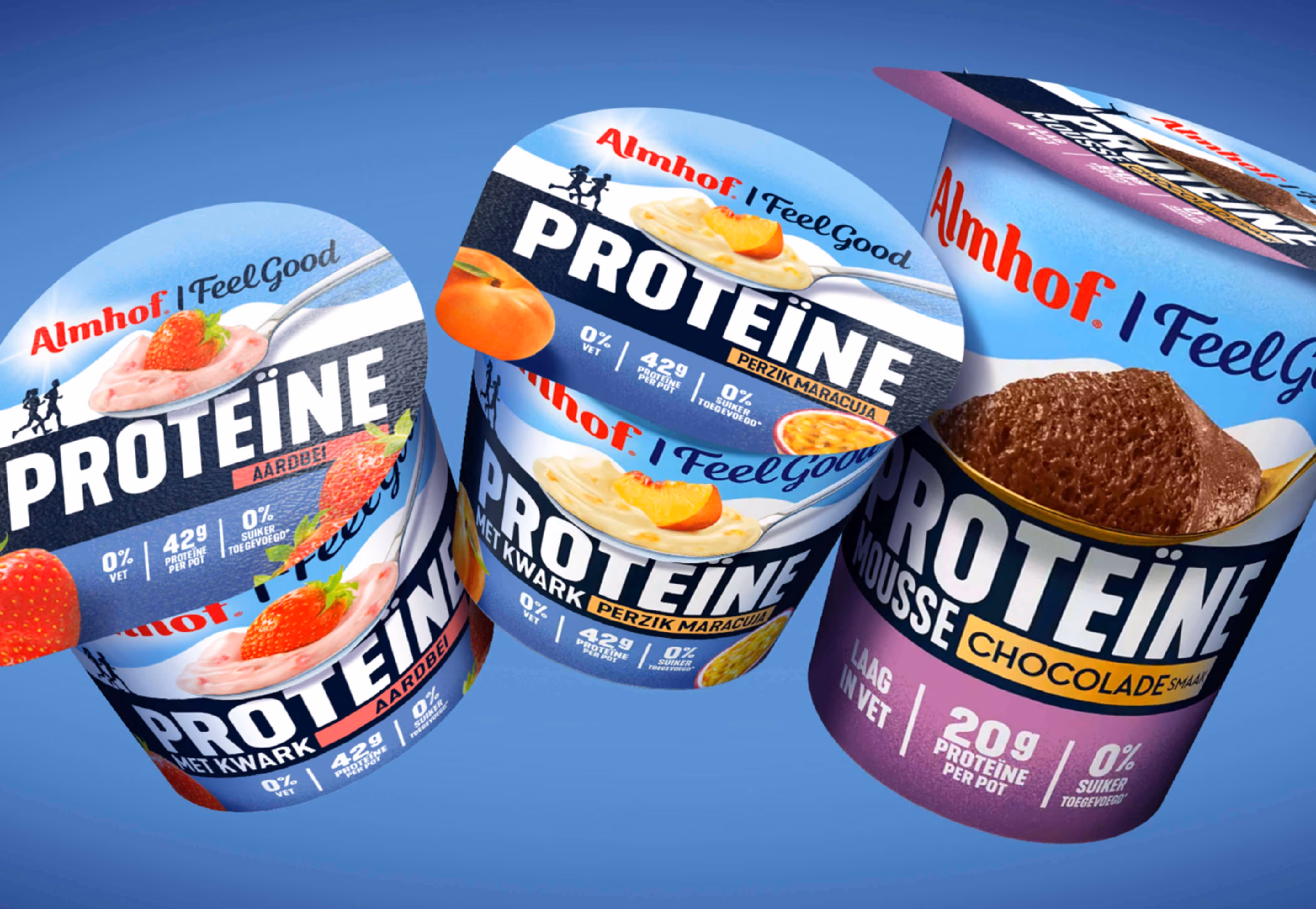 Three Almhof I Feel Good protein yogurt containers with flavors strawberry, peach passion fruit, and chocolate mousse against a blue background.