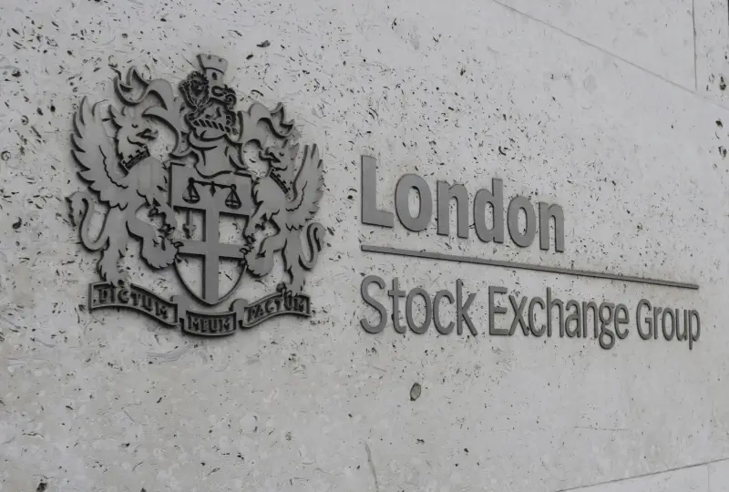 Stone wall with London Stock Exchange Group logo and emblem featuring a lion and griffin on either side of a shield.
