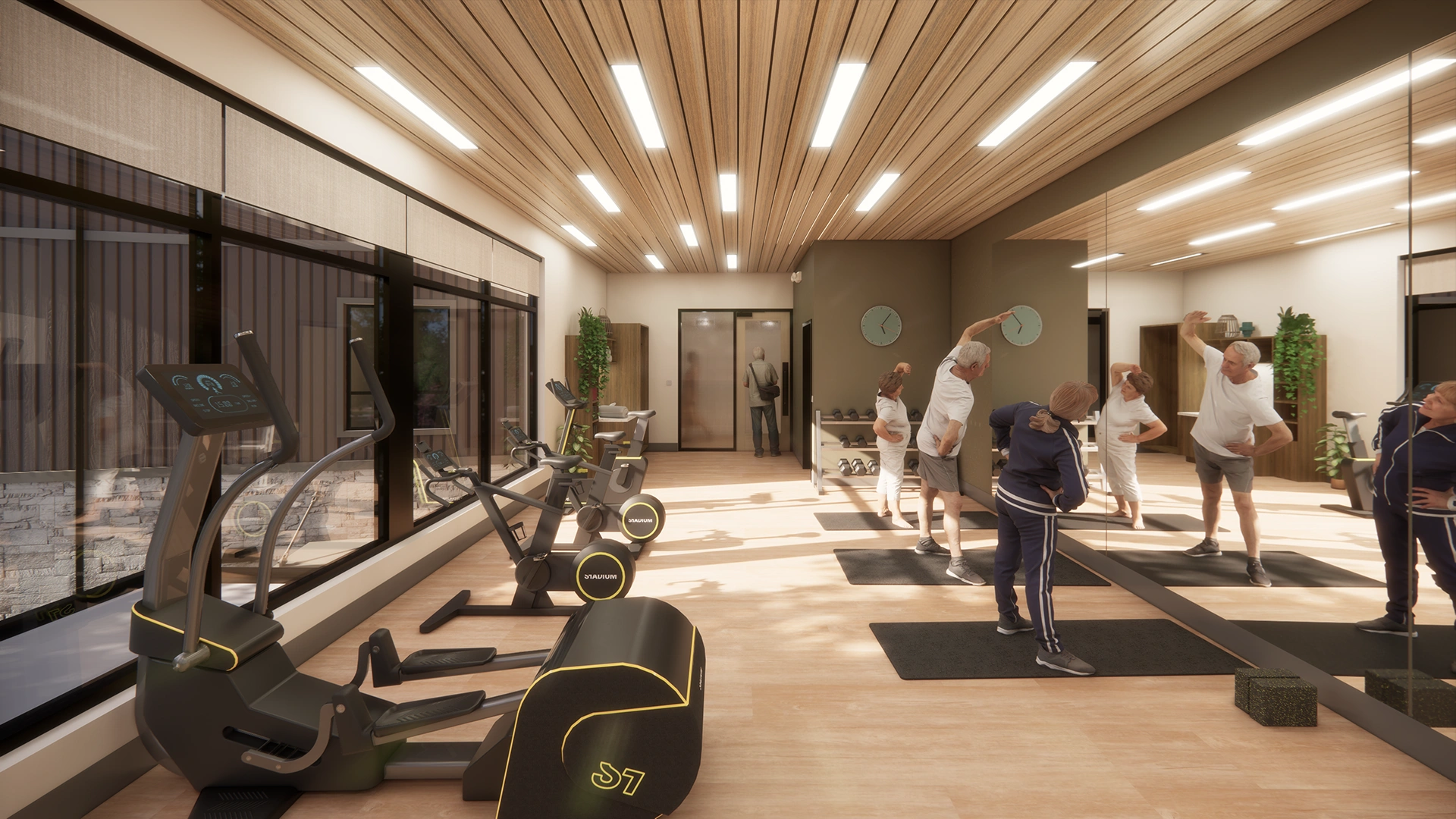 A modern fitness center with exercise bikes by large windows and a group of older adults stretching on mats in front of a wall mirror.