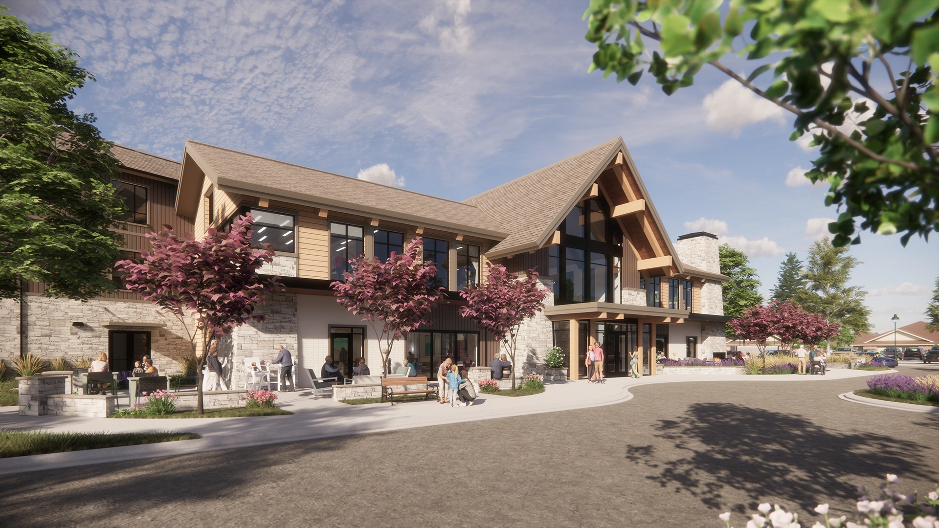 Sanavite Estates modern two-story clubhouse with large windows, stone and wood exterior, surrounded by trees and people walking and sitting outside.