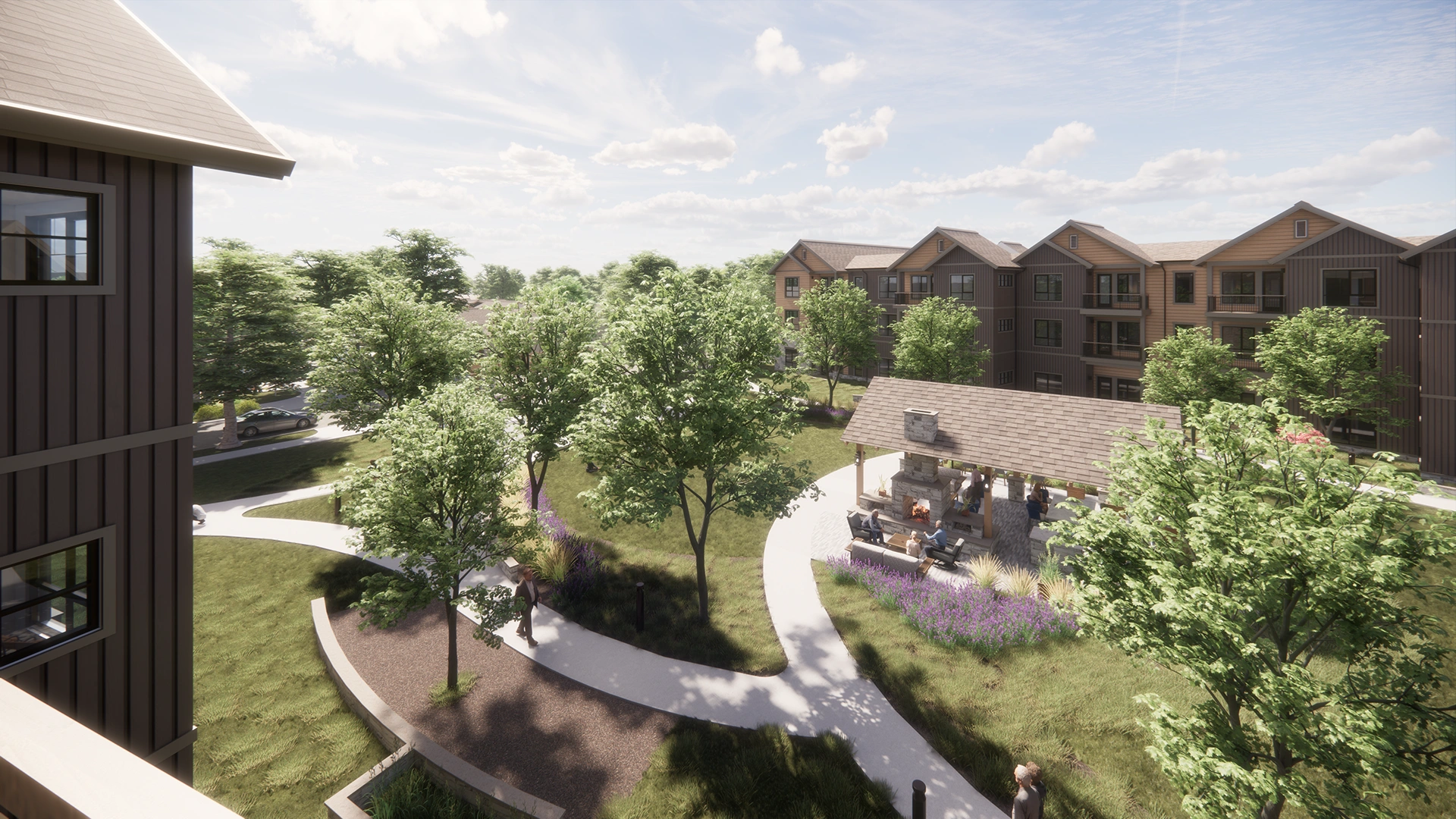 Outdoor courtyard with walking paths, trees, a covered seating area with a fireplace, and multi-story residential buildings in the background.