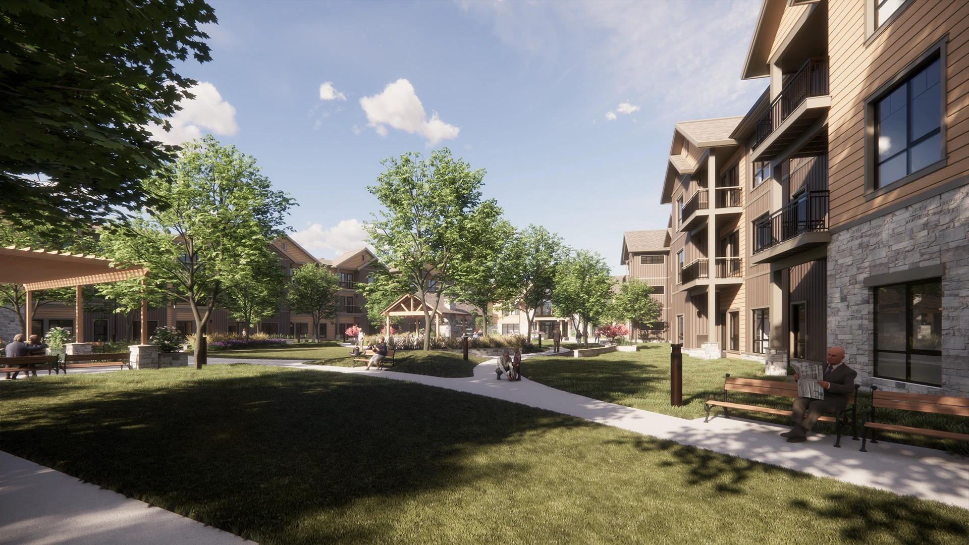 Sanavite Estates courtyard with green grass, trees, benches, and people sitting and walking near multi-story residential buildings under a clear sky.