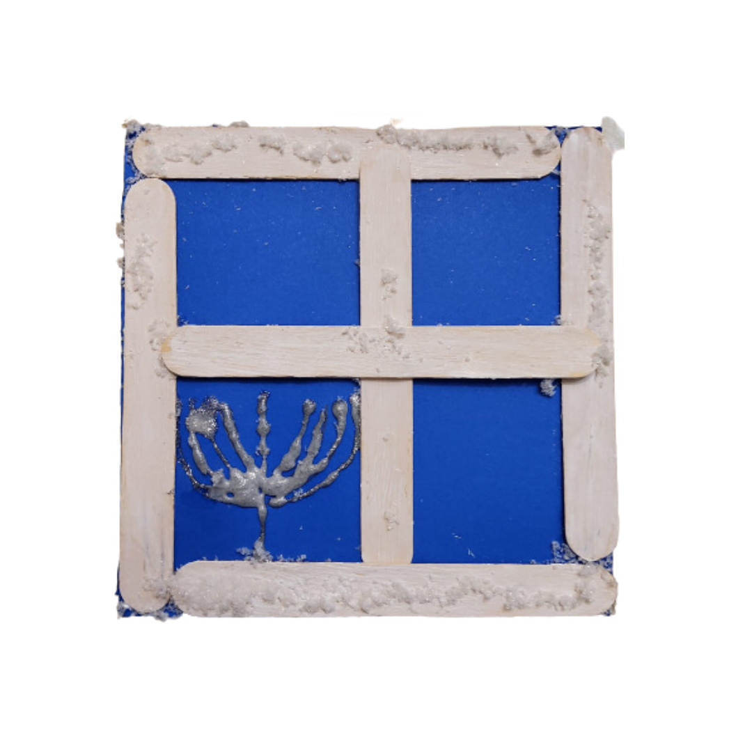 Craft project of a blue square with a white grid made from popsicle sticks and a silver menorah design in the bottom left corner.