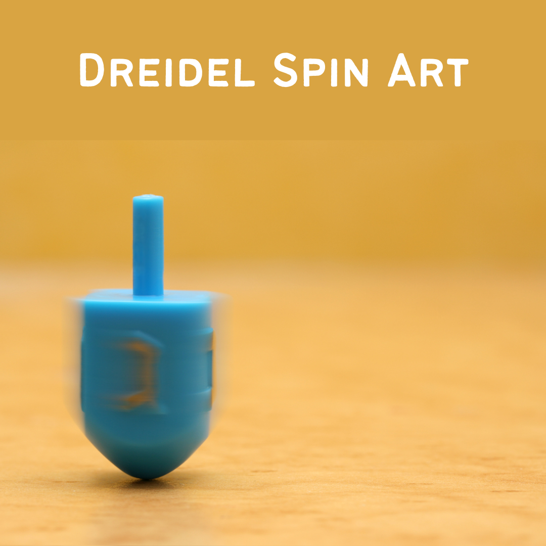 Blue dreidel spinning on a wooden surface with text 'Dreidel Spin Art' above it on a yellow background.