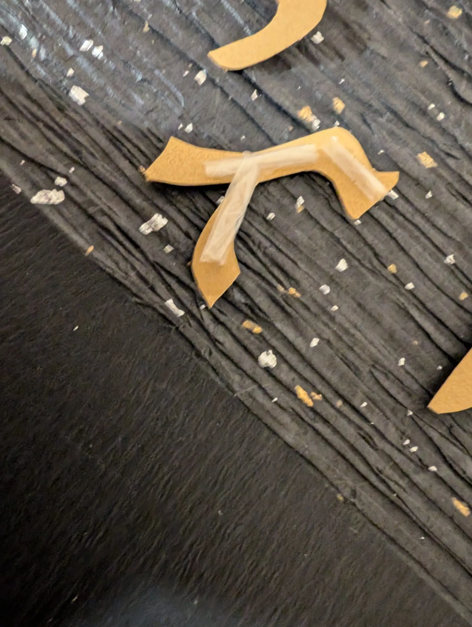 Gold Hebrew letters being pressed onto the black circle
