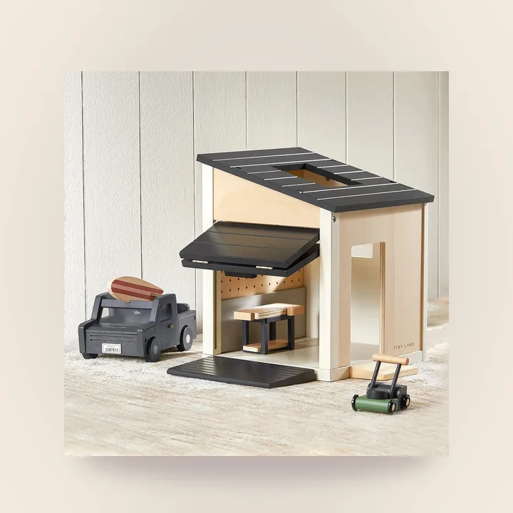 Wooden dollhouse garage with a truck and workbench