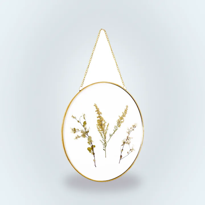 Gold circular frame with dried flowers