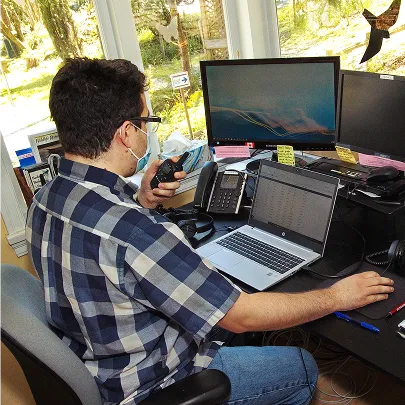 A staff member woking at a computer.