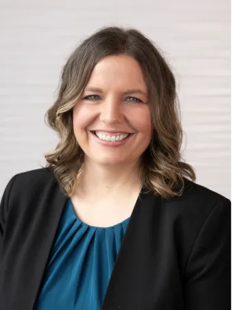 Jenilee Woltman, founder of Mission Accomplished, smiling in a professional headshot.