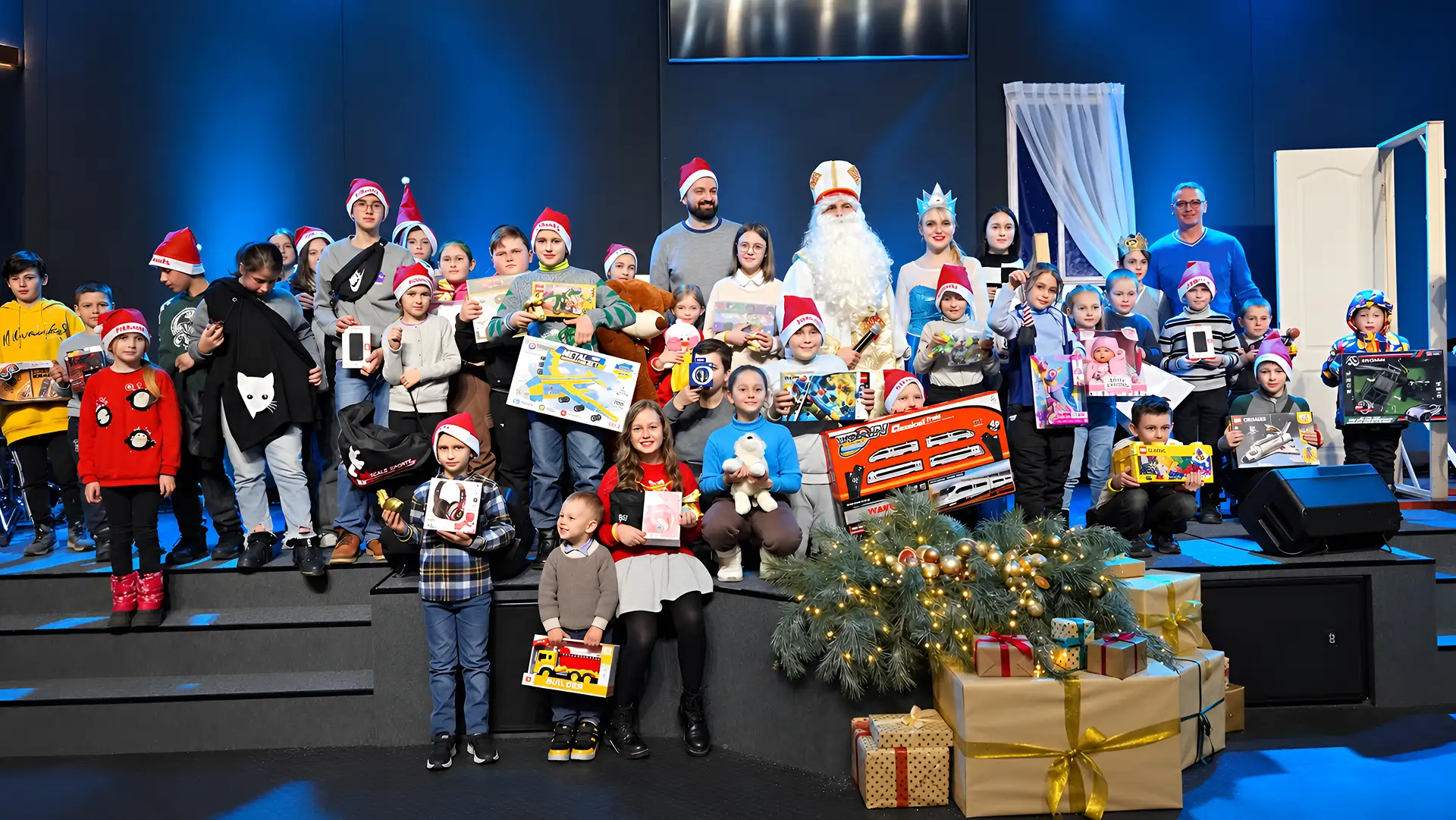 Children with gifts during a holiday event organized by Grow Up in a Family