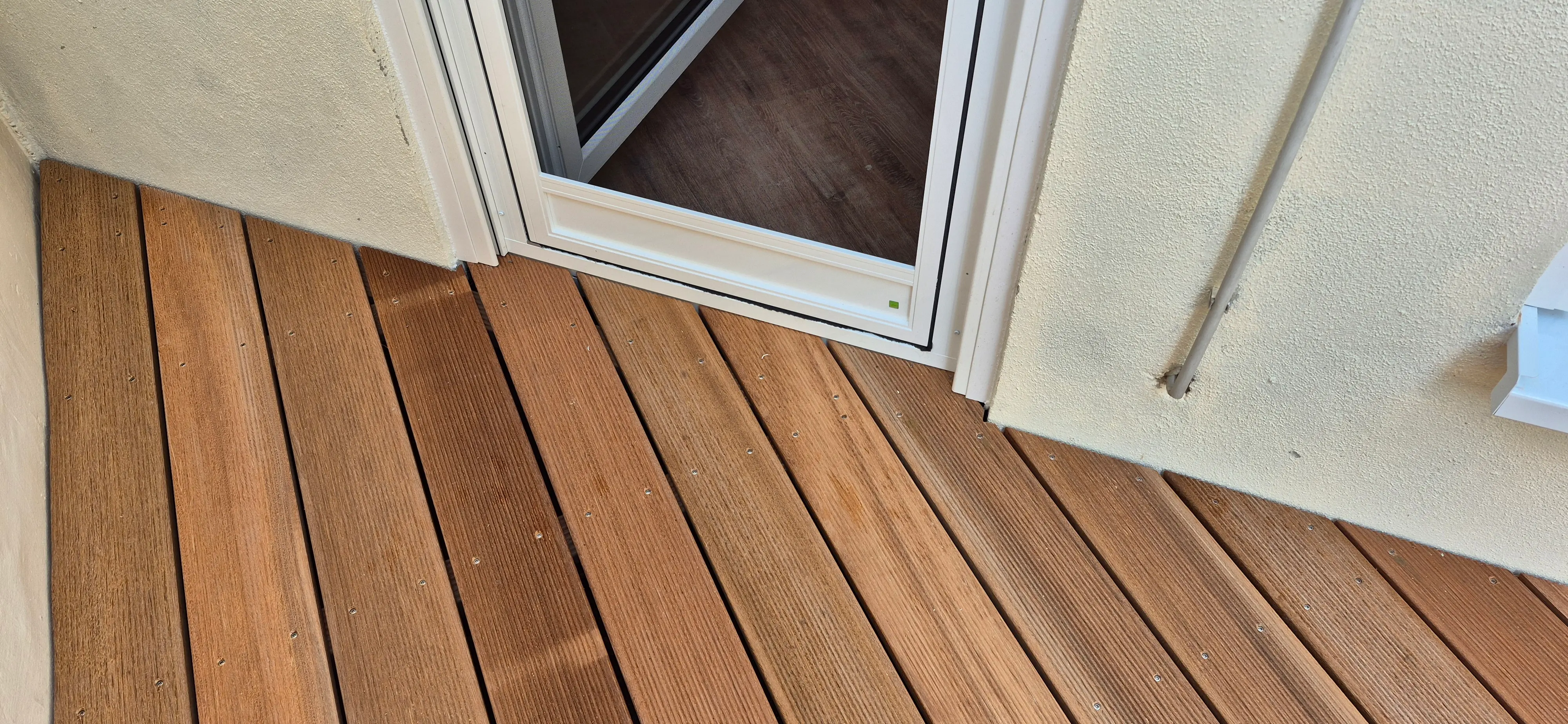 Detailaufnahme der geölten Bangkirai-Terrasse an der Balkontür mit präzisem Dielenverlauf in Sandhausen