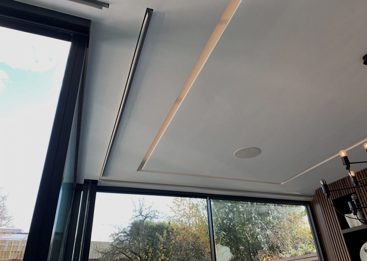 Ceiling recess housing hidden motorised blinds for a minimalist smart-home finish.