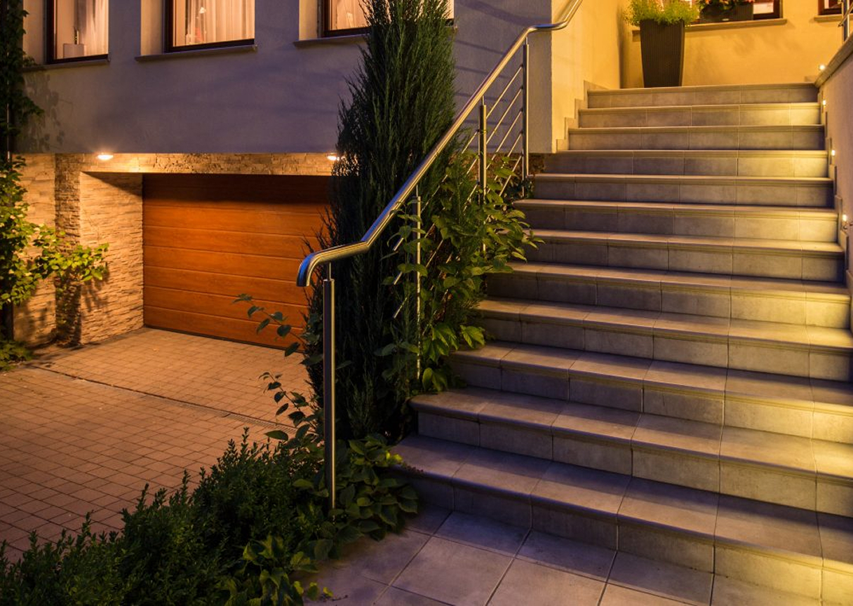 Contemporary home exterior featuring discreet up-lighting and pathway lights designed to highlight architectural and landscape features.