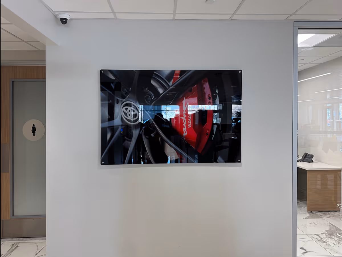 Silicon Edged Graphic Framed Fabric print of a Toyota Supra wheel and brake system in a modern office hallway.