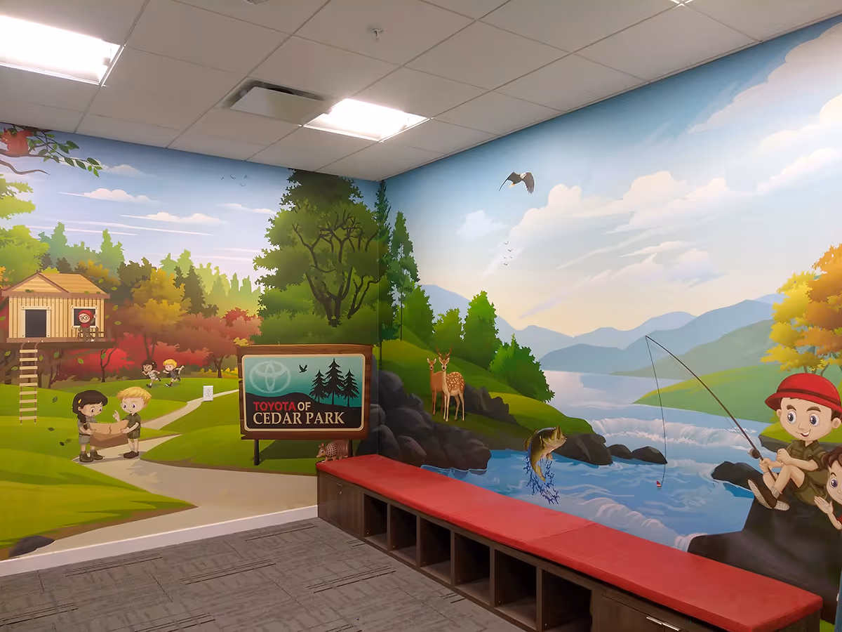 Children's room Wall mural showing cartoon kids in a park with a treehouse, playground activities, deer by a river, and a fishing boy wearing a red hat.