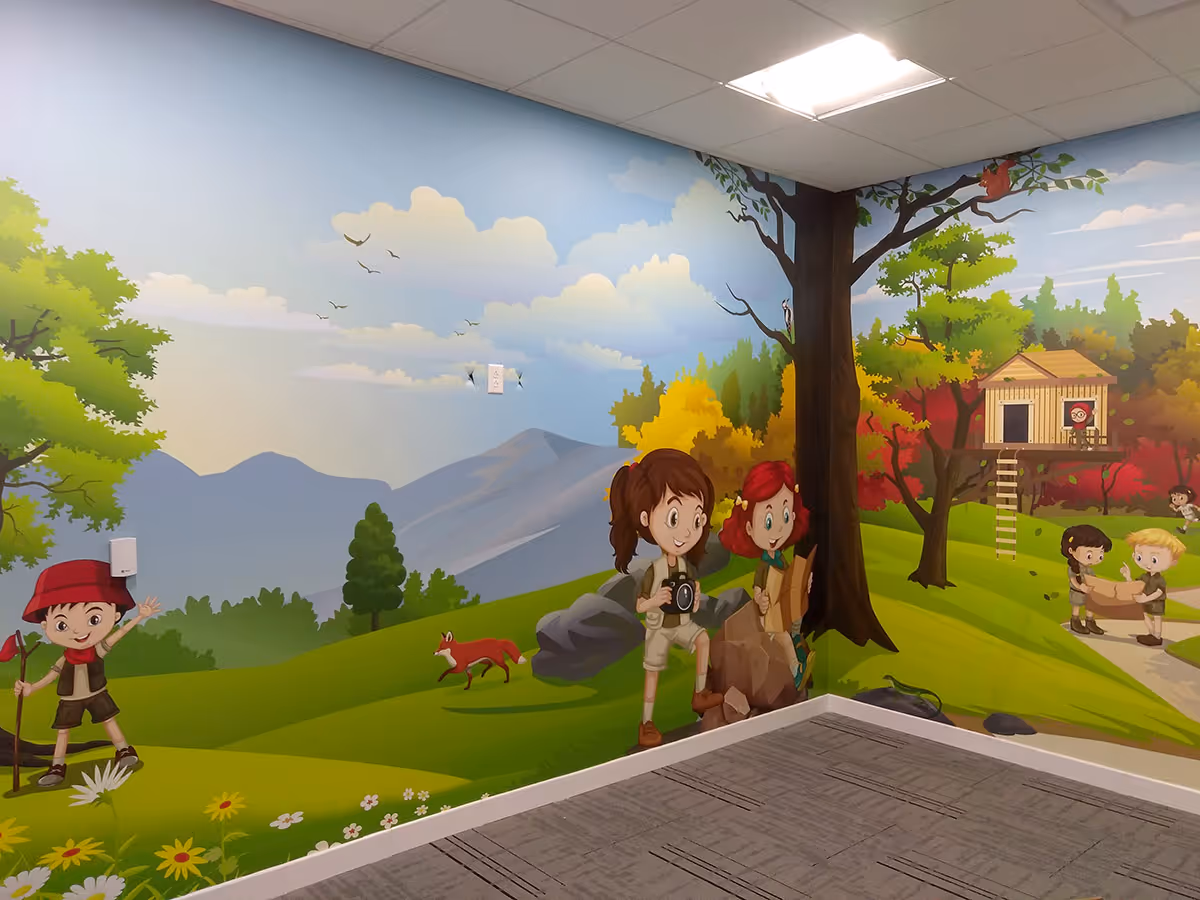 Colorful wall mural of children exploring nature with trees, flowers, mountains, a treehouse, and animals in a bright outdoor scene.