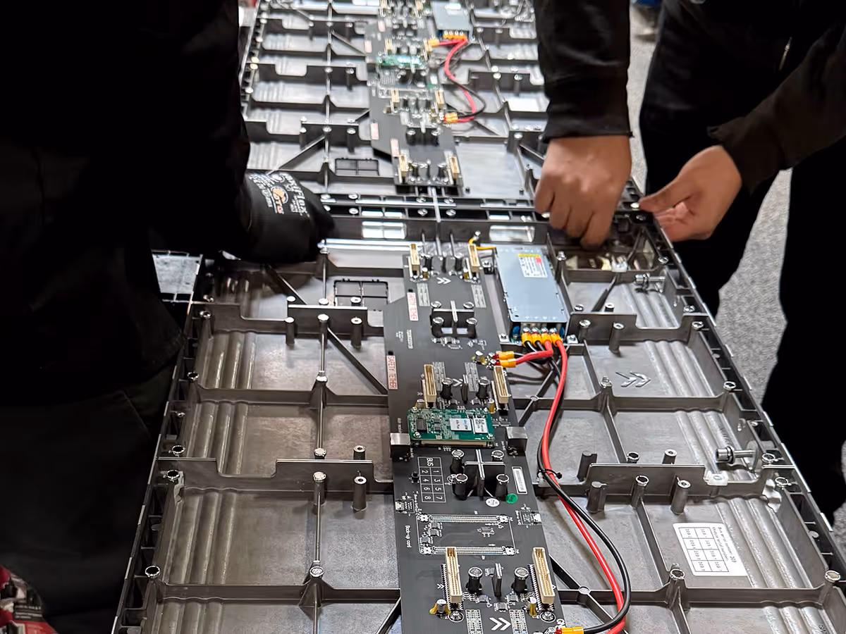 Fabricators installinga. video wall in the warehouse