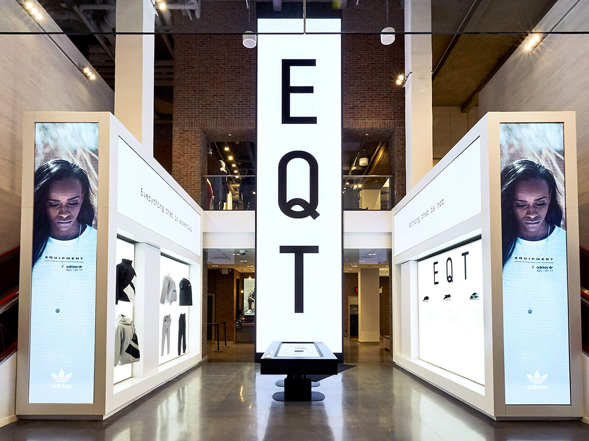 Hexagonal black pedestal with five compartments containing puzzle pieces and text labels on a wooden floor.