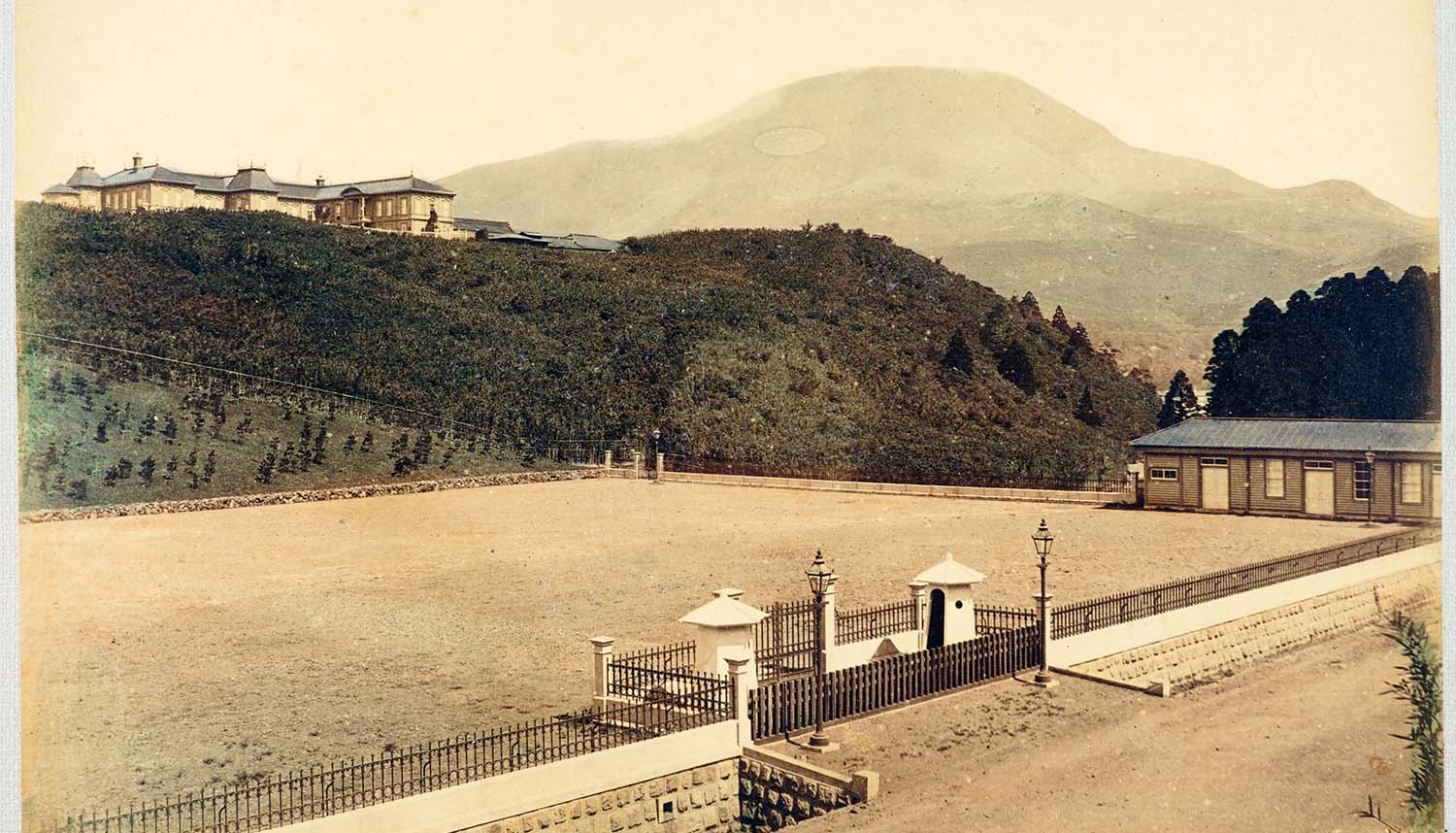 Hand-coloured historic photograph of the original Hakone Imperial Villa overlooking its grounds in the Meiji era