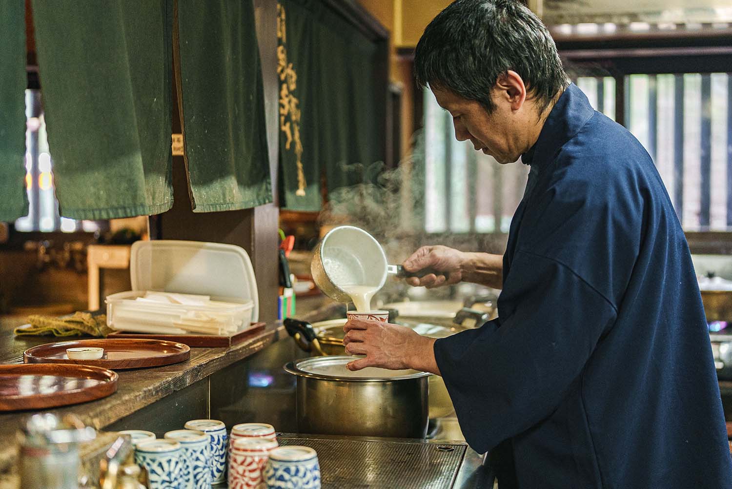 Inside the Amasake Chaya, with its earthen floor and aged wooden pillars