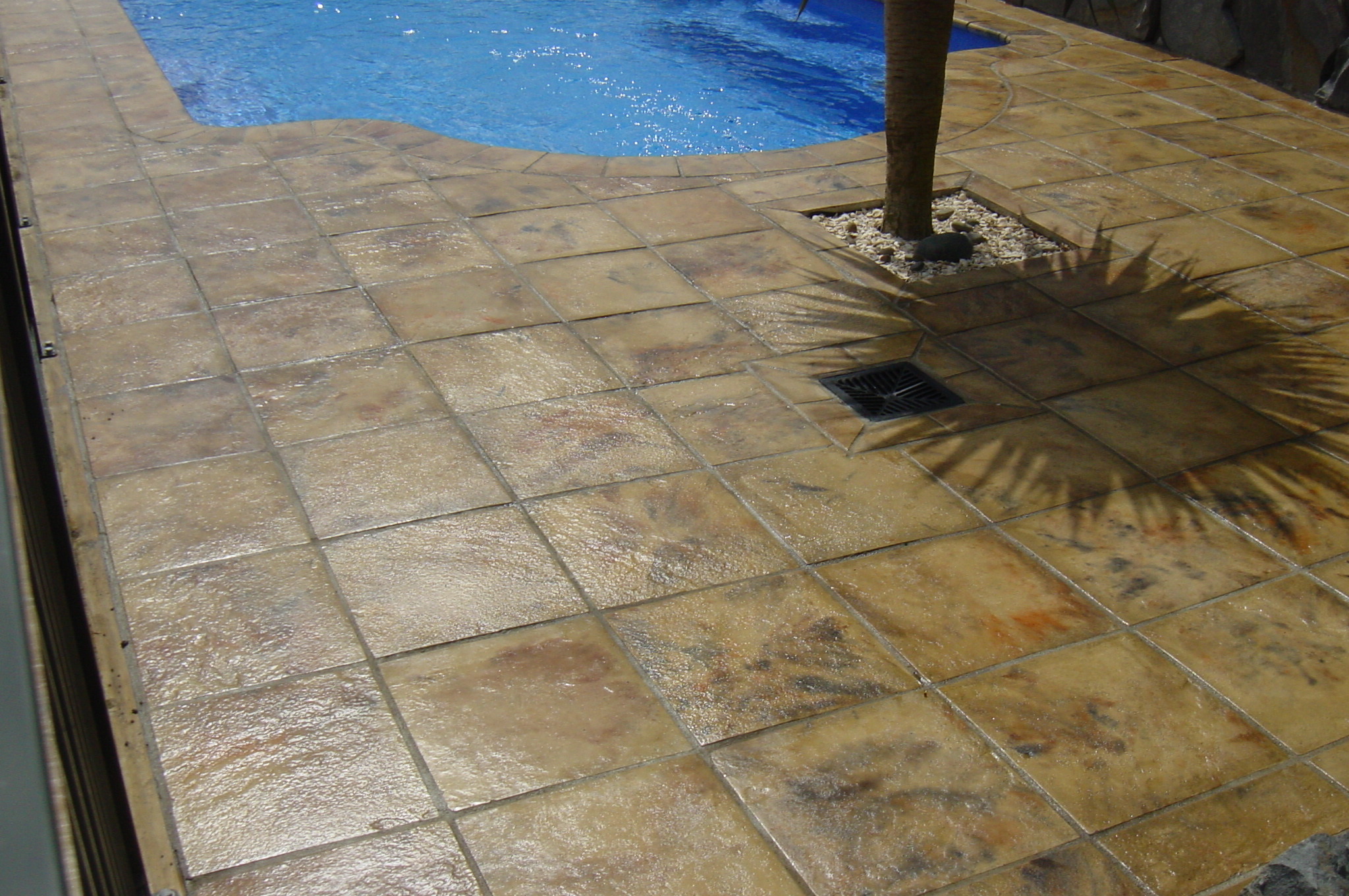 Pool with concrete pavers surrounding it by The Paving Lab Company.