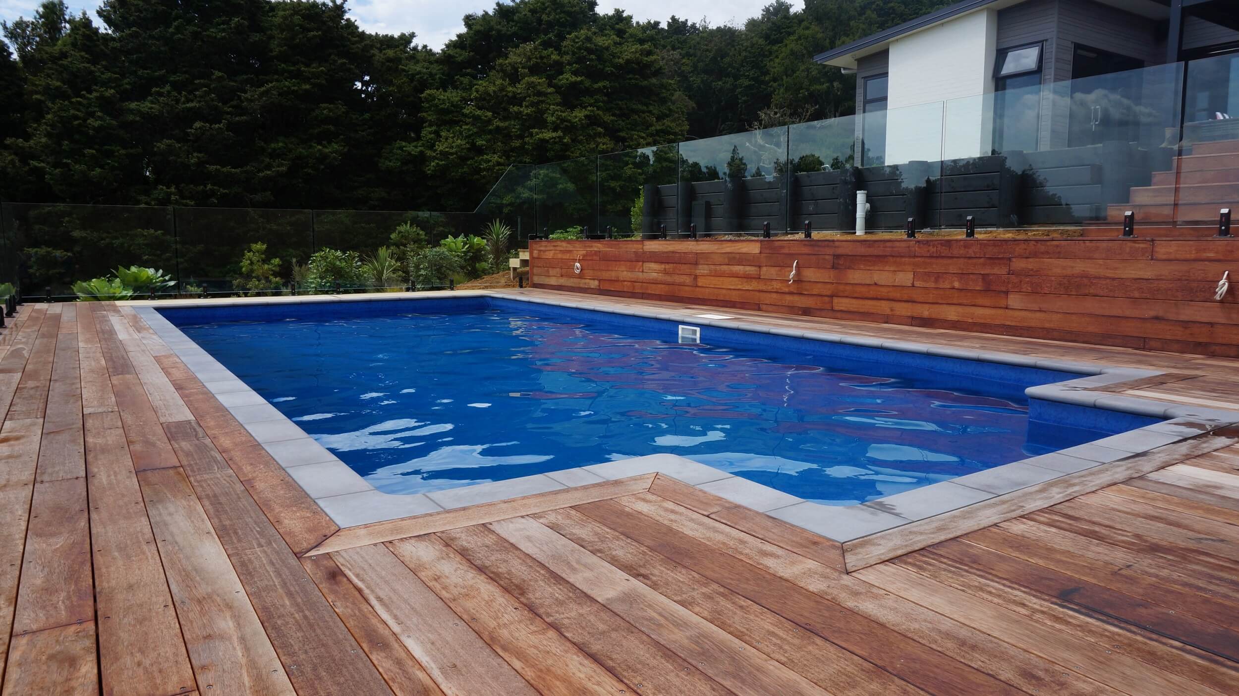 A pool with concrete coping by The Paving Lab Company.