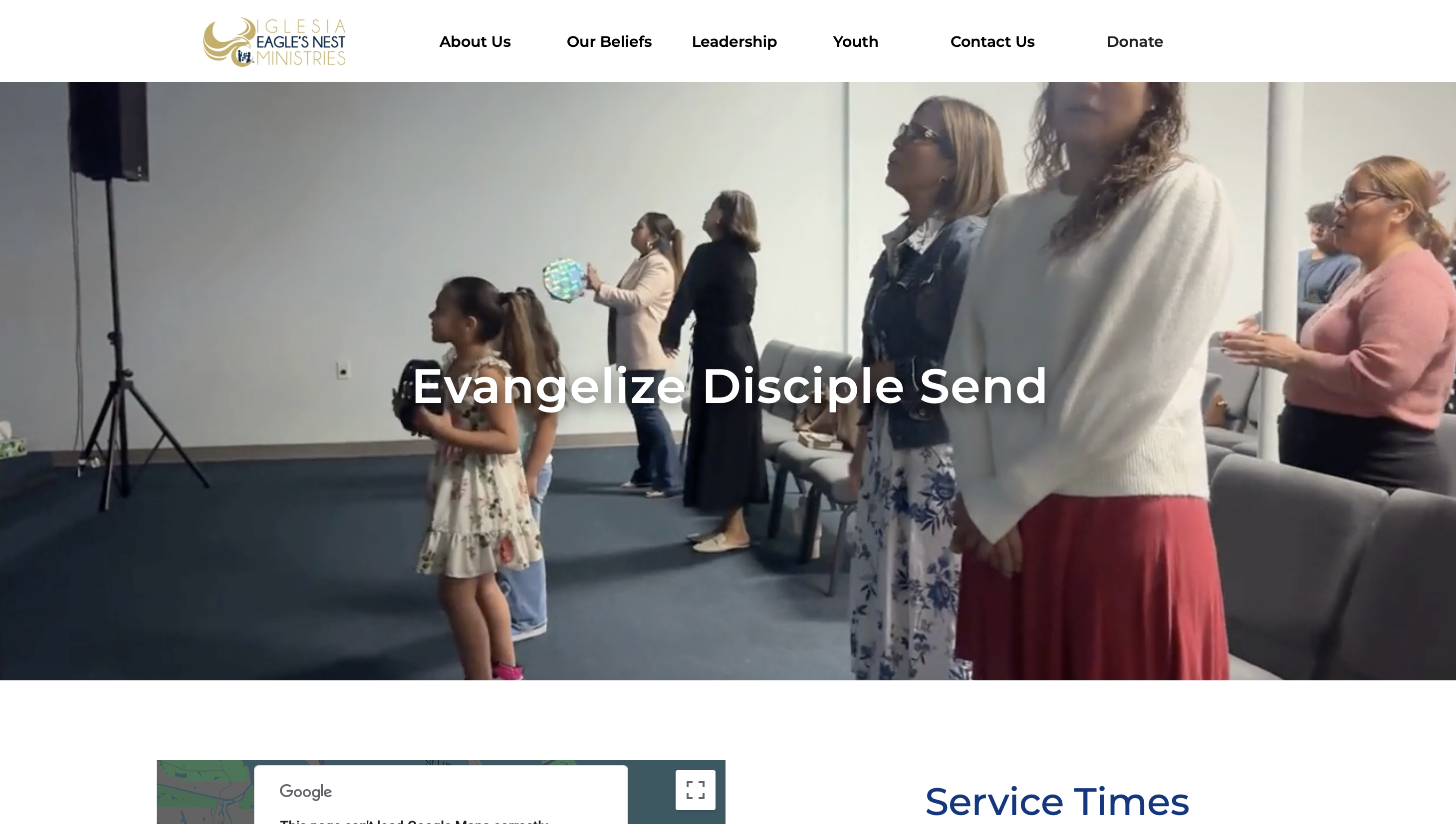 Homepage hero section of website, showing people worshiping in a church service with the headline “Evangelize Disciple Send” and a top navigation menu (About Us, Our Beliefs, Leadership, Youth, Contact Us, Donate).