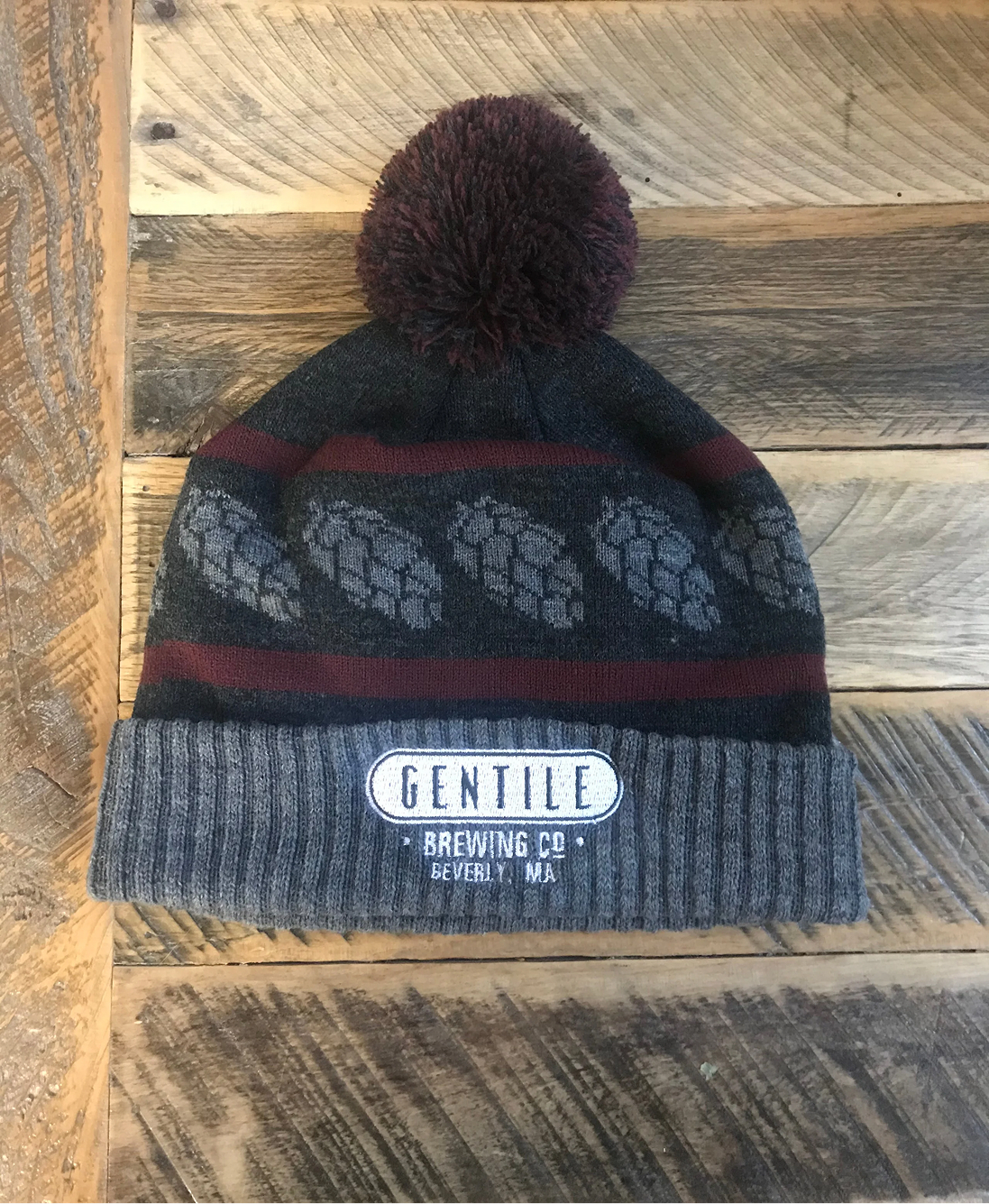 Gray knit beanie with pom-pom, hop cone pattern, and Gentile Brewing Co. Beverly, MA logo patch.