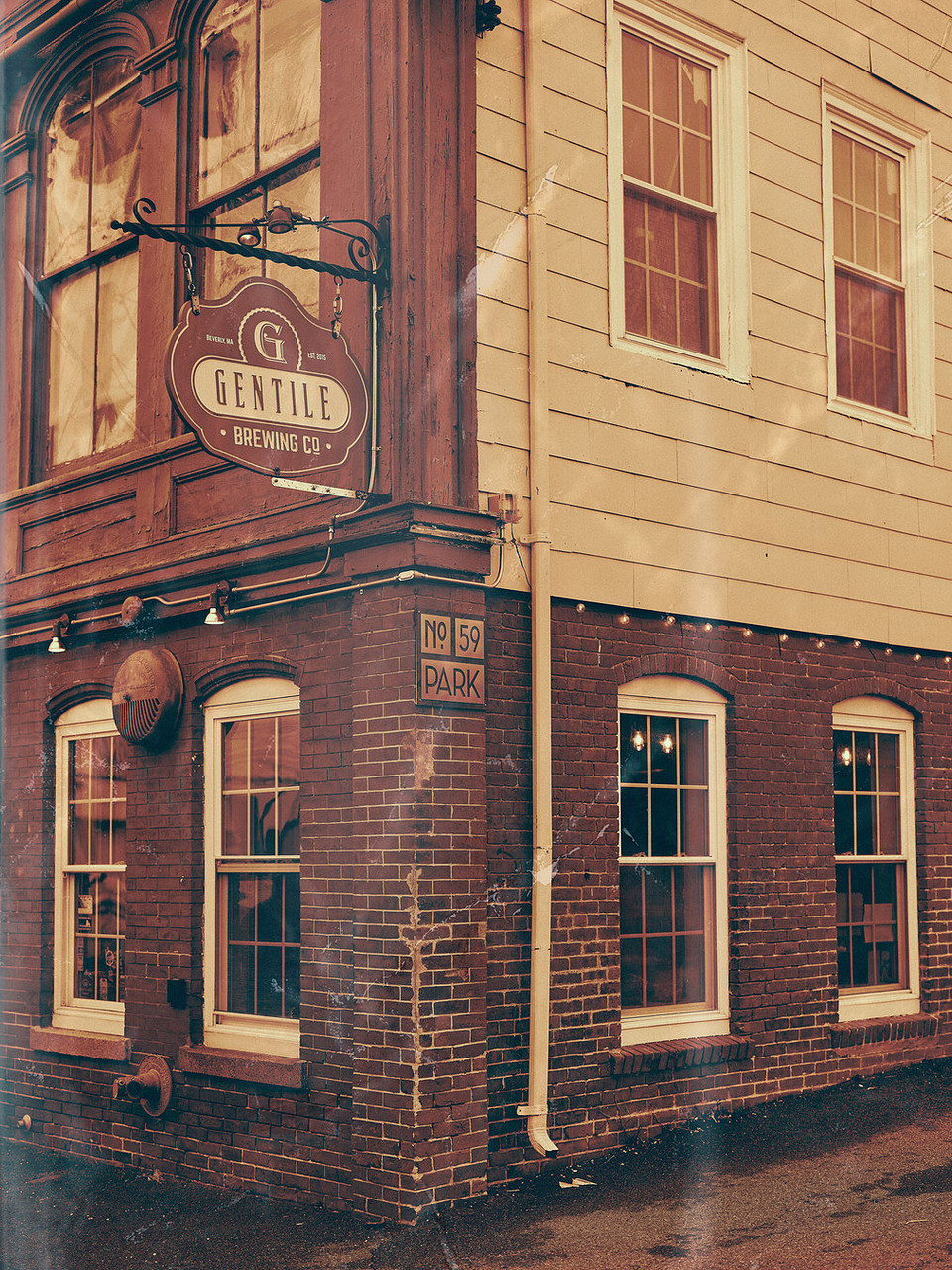 Corner building with Gentile Brewing Co. sign and address number 59 Park on brick wall.