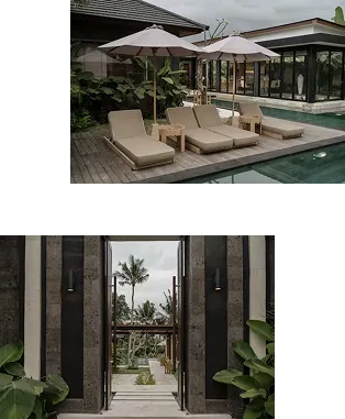 Outdoor pool area with three lounge chairs under umbrellas and a modern building with large windows.