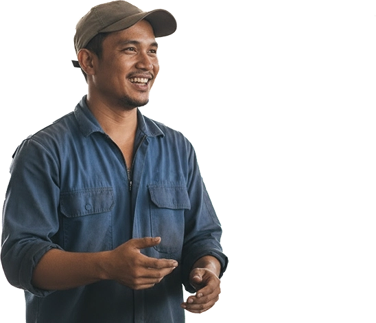 Smiling man in a blue work shirt and cap gesturing with his hands.