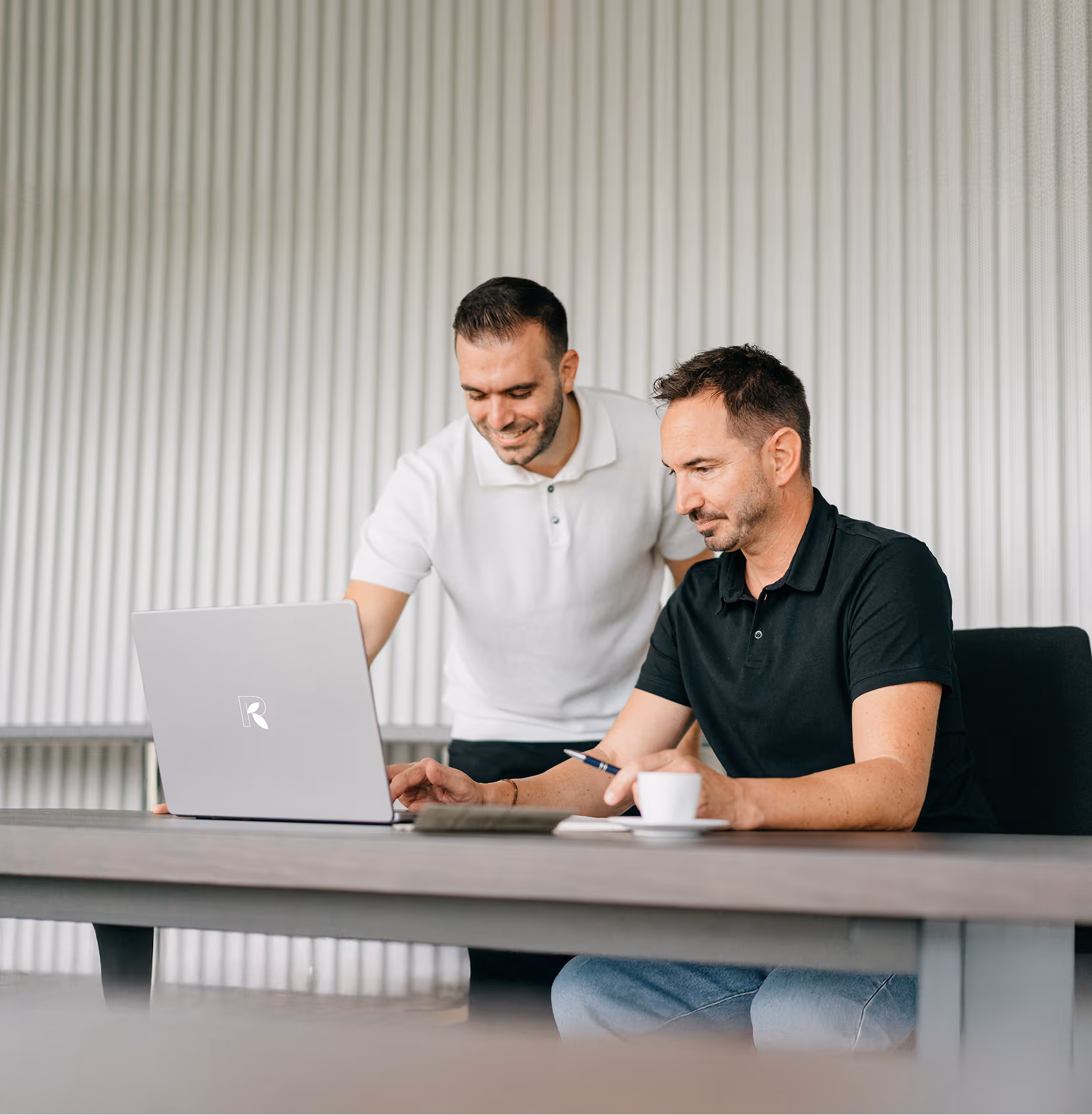 Roland Koch Transporte Schweiz: Teamarbeit am Laptop im modernen Büro