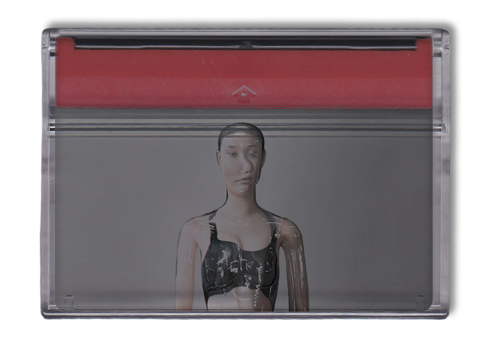 Retro clear cassette tape with red top containing image of a female in a transparent mannequin next to text reading, 'This is not about vanity. Some people try to feel like they need to fit a certain mold in an attempt to look "normal."'