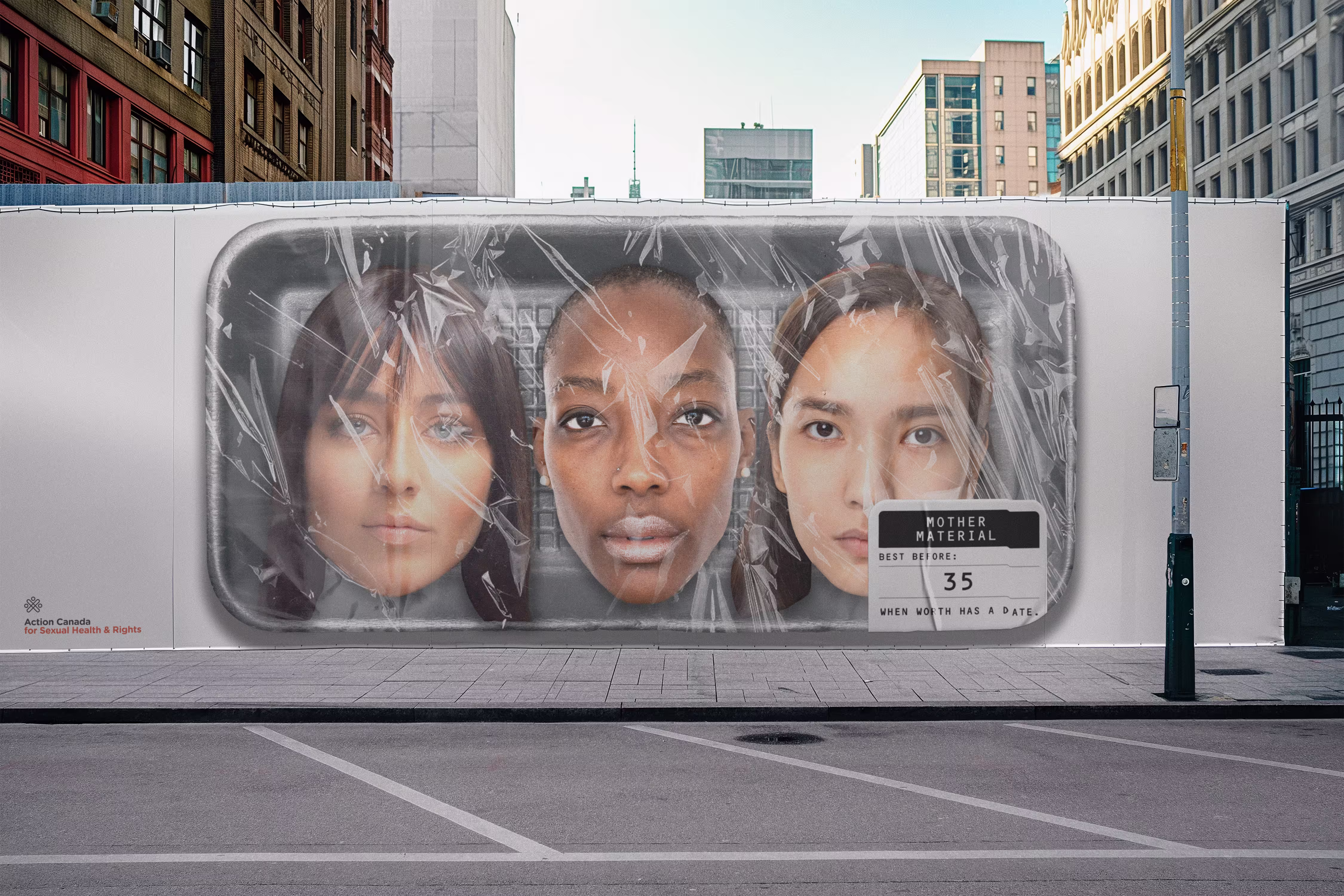 Street mural of three women's faces wrapped in plastic with a label reading 'Mother Material best before: 35 when worth has a date.'