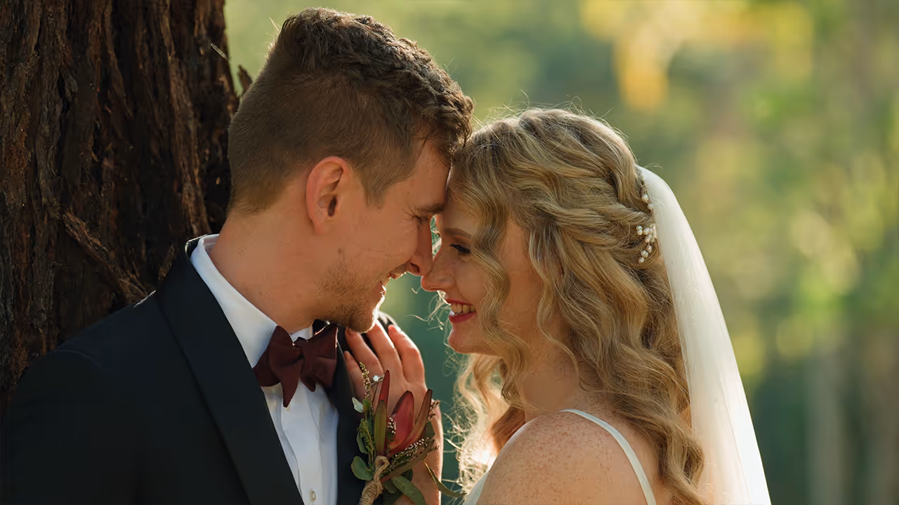 Bride and groom share a joyful moment together beneath soft afternoon light, captured in elegant cinematic style by Creo Bella.