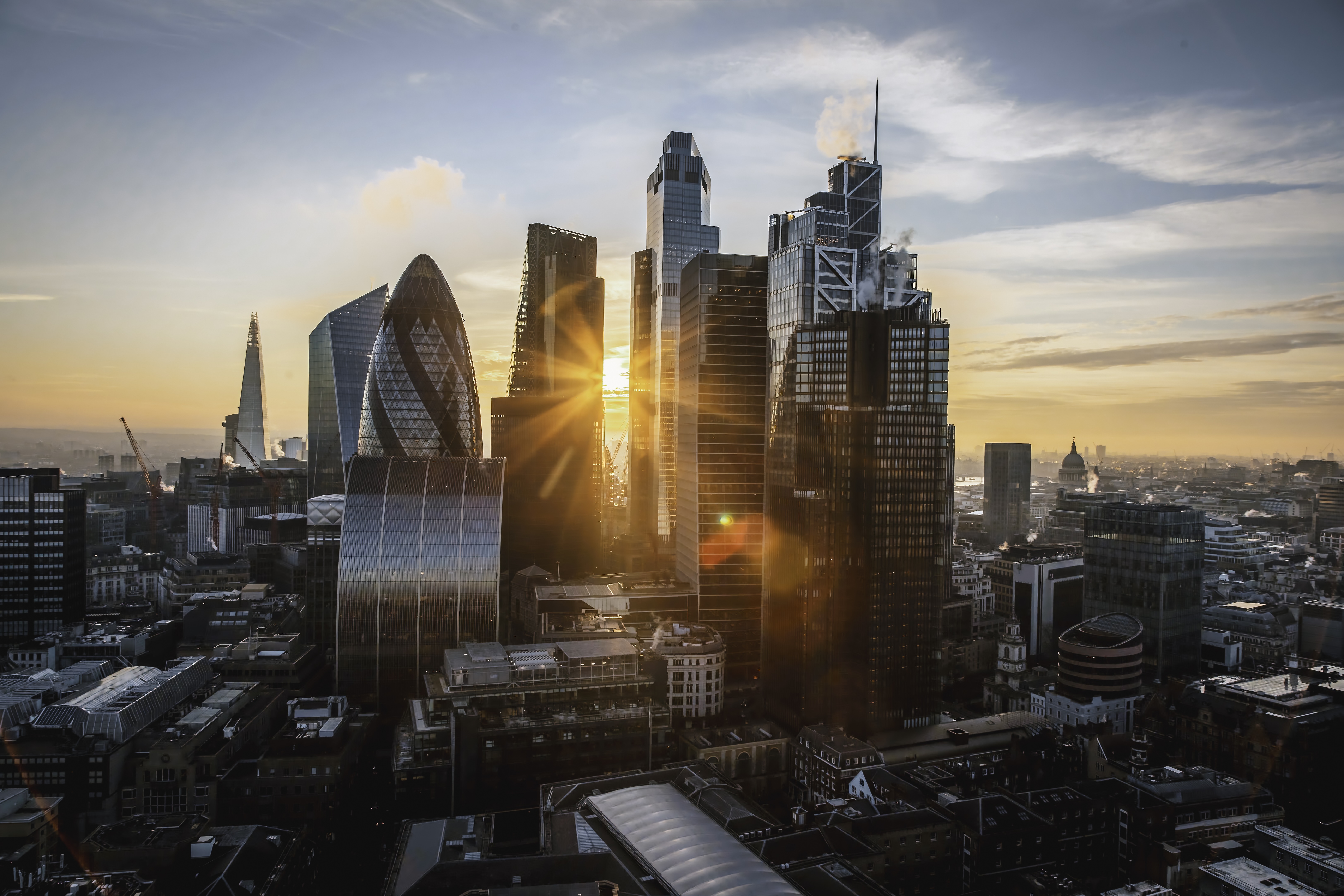 Two women in professional attire, illustrating the concept of following fashion trends for 2025.