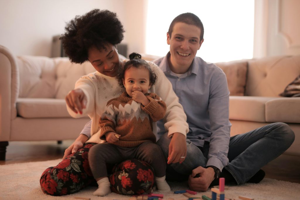 Couples sitting on their carpet.