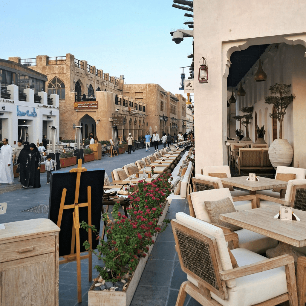 A bustling outdoor market with traditional architecture and cozy café seating arrangements.