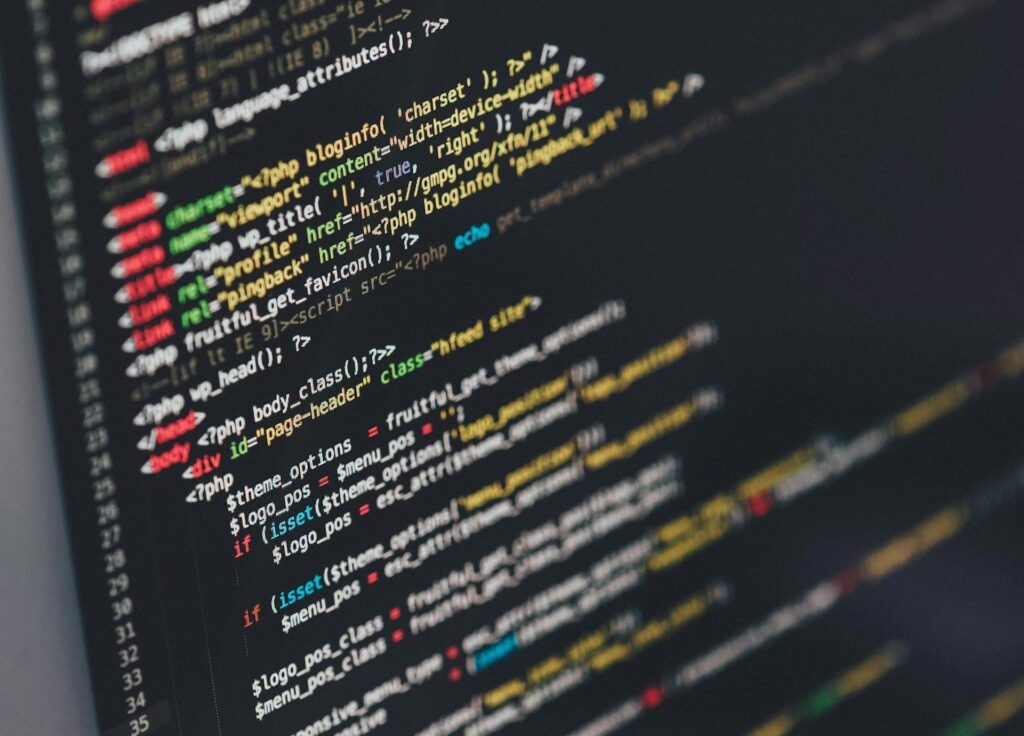 Lines of colorful code displayed on a dark computer screen, showcasing programming syntax.